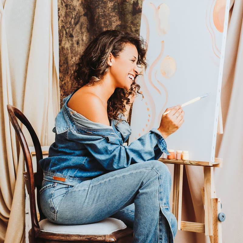 women painting in jeans